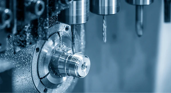 Horizontal CNC spindle drilling into a metal part with coolant